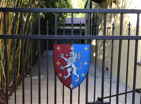 Metal family coat of arms shield on iron gate